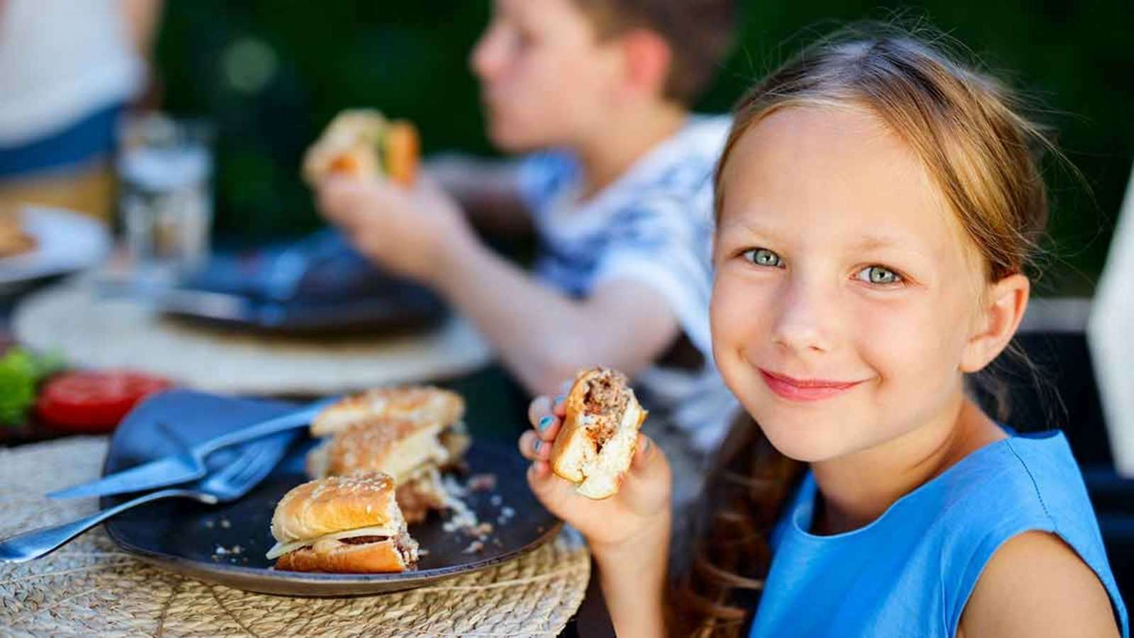 child eating burger
